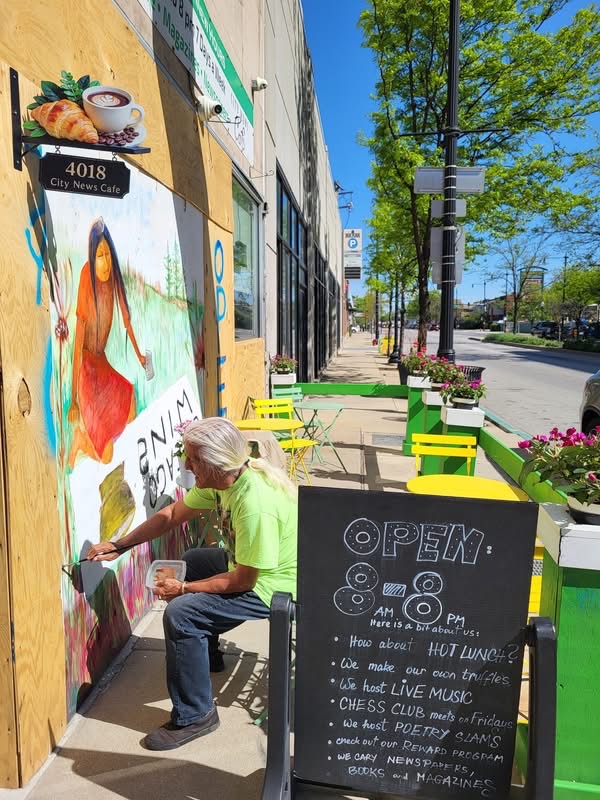 art being painted on city newsstand