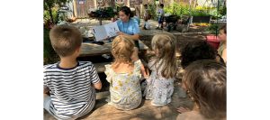 Teacher from Creativo Preschool reads to children